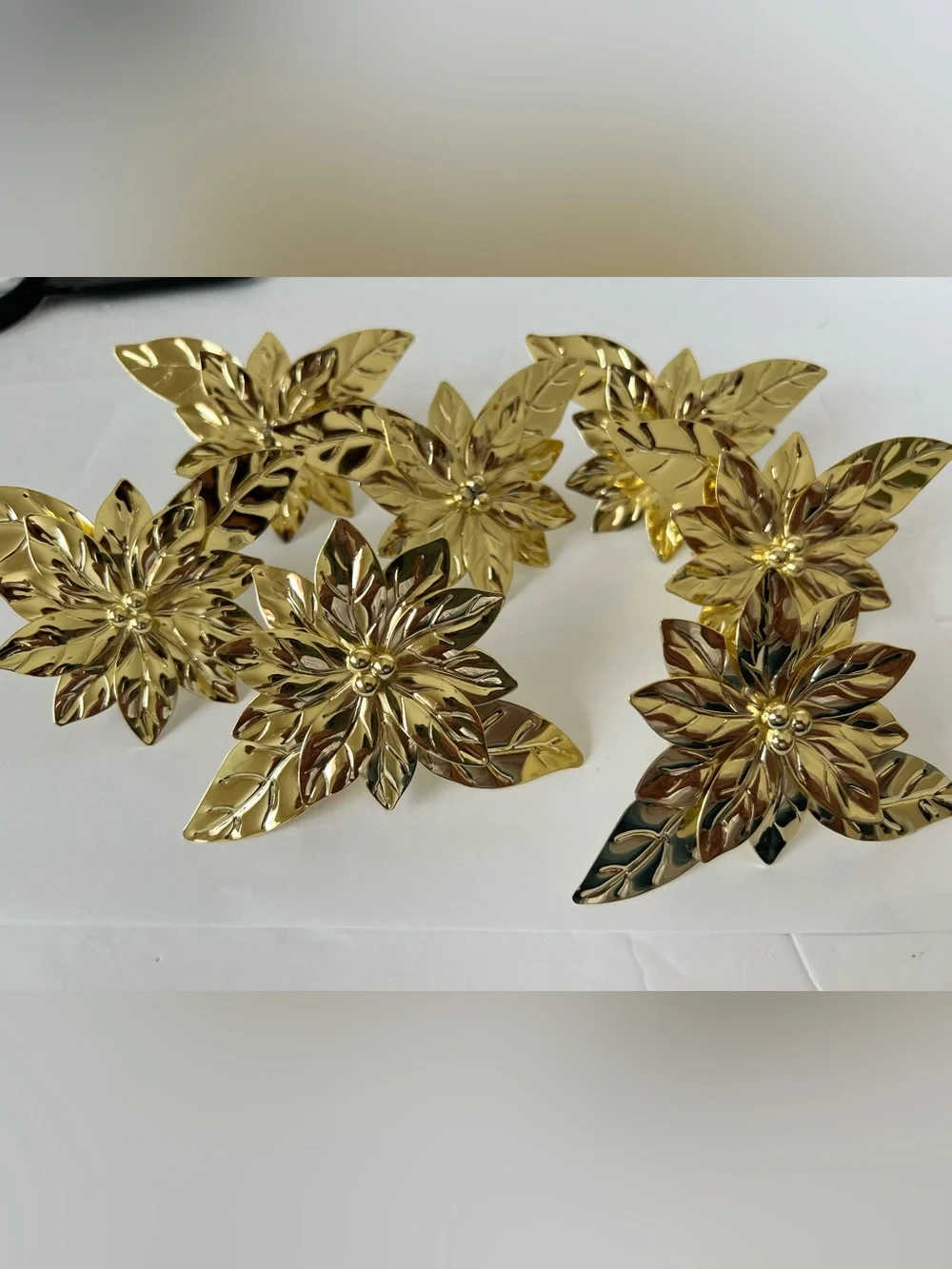 Pre-owned, barely used, gold-tone Poinsettia Napkin Rings -Set of 7